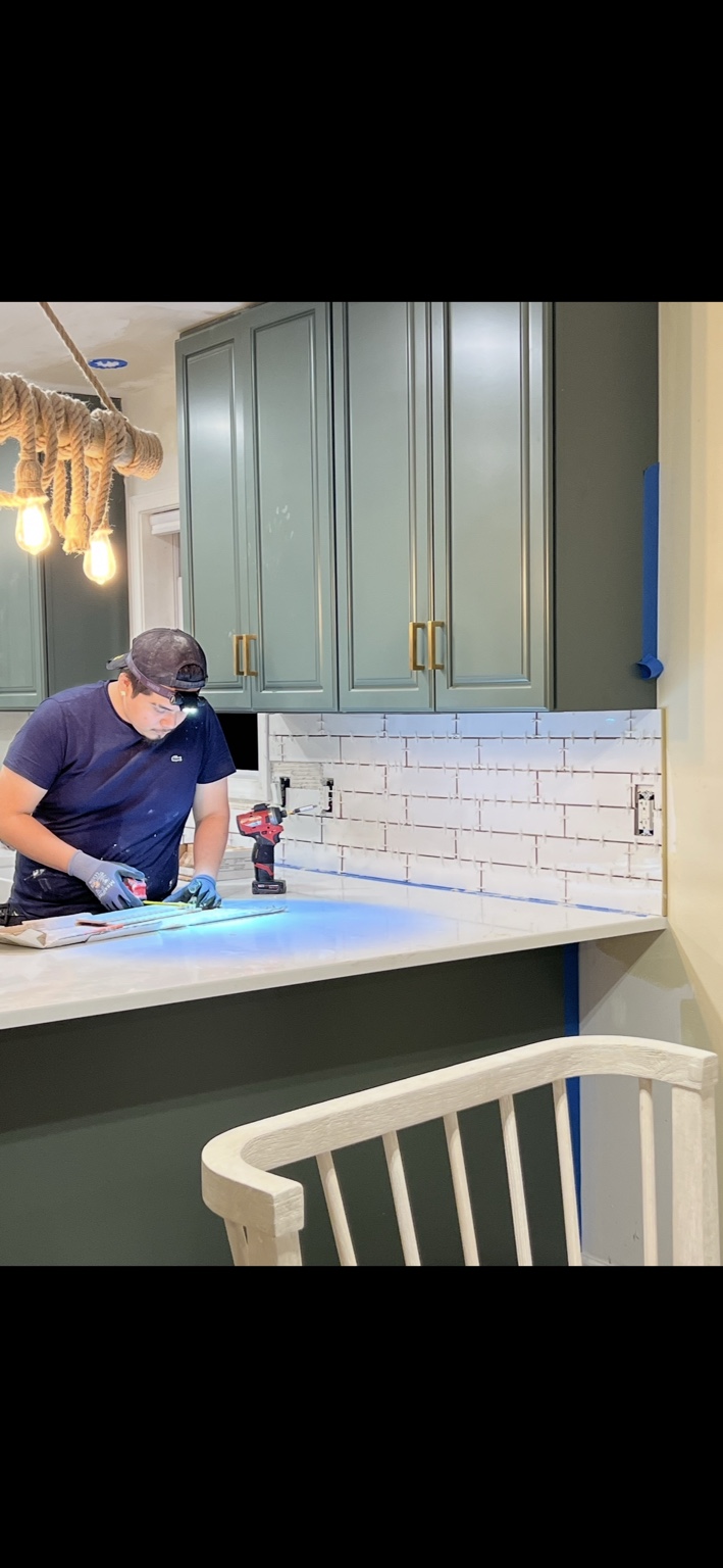 Hugo completing a detailed kitchen backsplash installation